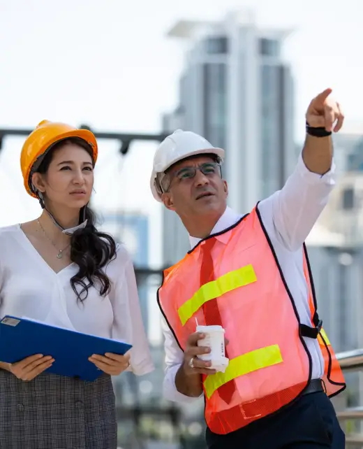 two-engineers-man-and-woman-in-safety-helmets-and-2023-11-27-04-54-51-utc